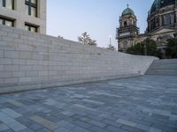 the stairs lead up to the cathedral with an ornate dome in the background on a clear day