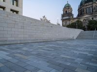 the stairs lead up to the cathedral with an ornate dome in the background on a clear day