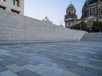 the stairs lead up to the cathedral with an ornate dome in the background on a clear day