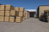 a large garage filled with lots of boxes and crates of hay stacked up to the side