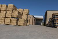 a large garage filled with lots of boxes and crates of hay stacked up to the side