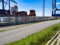 this is an image of a port area with an industrial cranes and a container ship