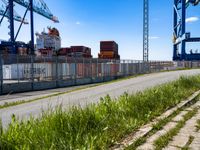 this is an image of a port area with an industrial cranes and a container ship