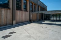 a parking spot and a lot of wooden panels on the exterior of a building in a city