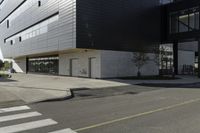 some people are walking across a crosswalk near a large building while two zebra crossing crosses are near