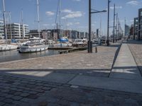 a brick path next to marina filled with lots of boats parked next to each other