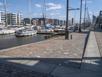 a brick path next to marina filled with lots of boats parked next to each other