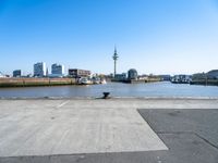 a street with a car parking lot on it with a blue sky and city in the background