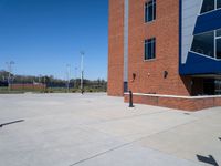 the empty courtyard at a building near an intersection with a bus stop light and an american flag