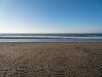 there is an image of an empty beach and ocean view area in the background on a sunny day