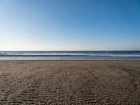 there is an image of an empty beach and ocean view area in the background on a sunny day