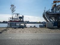 the boat is docked in the dock next to a building and an ocean front dock