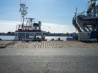 the boat is docked in the dock next to a building and an ocean front dock