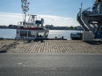 the boat is docked in the dock next to a building and an ocean front dock