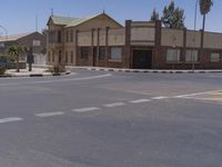 a building with the sign that reads to the right of the road is a closed street, with a yellow line on the road in front of it, and some buildings