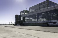 the sidewalk is empty during the day and empty around the corner of it, and the large building with two windows has been moved