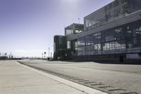 the sidewalk is empty during the day and empty around the corner of it, and the large building with two windows has been moved