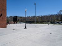 a clock tower sits in the middle of a parking lot with parking meters on each end