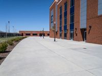 there is an empty parking lot at an empty elementary school yard area with the sign at one end and a no parking sign on it