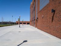 there is an empty parking lot at an empty elementary school yard area with the sign at one end and a no parking sign on it