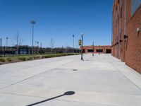 there is an empty parking lot at an empty elementary school yard area with the sign at one end and a no parking sign on it