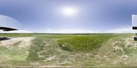 a split - shot of the panorama lens of an airplane in the sky above a road near grass and a road