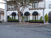 a picture of a building that has an entrance and trees in the front of it