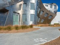 modern architecture with a unique sculpture in the background, in front of a white wall