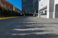 a sidewalk is in the middle of some buildings with a man walking down it on the street