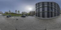 360 cameras showing some cars parked on the side of road beside buildings in large city area