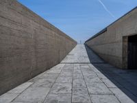 Clear Sky in Porto: Straight Road with Concrete Walls