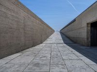 Clear Sky in Porto: Straight Road with Concrete Walls