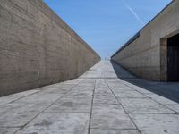 Clear Sky in Porto: Straight Road with Concrete Walls