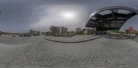 there is a convex reflection on the front of a building at an intersection, seen through a fish eye lens