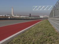 an empty track at a motorsports club with some red and white stripeing on it