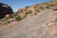 a man standing next to a large rock in a canyon with no vegetation on the rocks