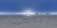 the sun is shining over a vast plain of desert land, in front of some mountains