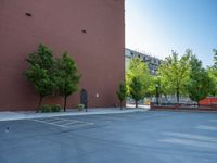 a paved street has been painted light gray, with gray brick walls and concrete edges