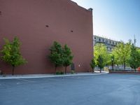 a paved street has been painted light gray, with gray brick walls and concrete edges