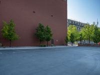 a paved street has been painted light gray, with gray brick walls and concrete edges