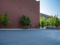 a paved street has been painted light gray, with gray brick walls and concrete edges