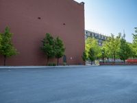 a paved street has been painted light gray, with gray brick walls and concrete edges