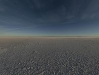 the sky is clear as it sits on the snowy field in the middle of the desert