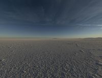 the sky is clear as it sits on the snowy field in the middle of the desert