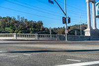 this city street is marked for an intersection where there is a tall column with a white top and columns along it