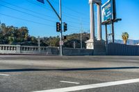 this city street is marked for an intersection where there is a tall column with a white top and columns along it