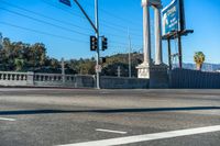 this city street is marked for an intersection where there is a tall column with a white top and columns along it