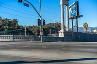 this city street is marked for an intersection where there is a tall column with a white top and columns along it