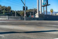 this city street is marked for an intersection where there is a tall column with a white top and columns along it