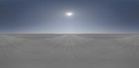 the sky is blue as it passes through a sunbeamed horizon over a sandy area